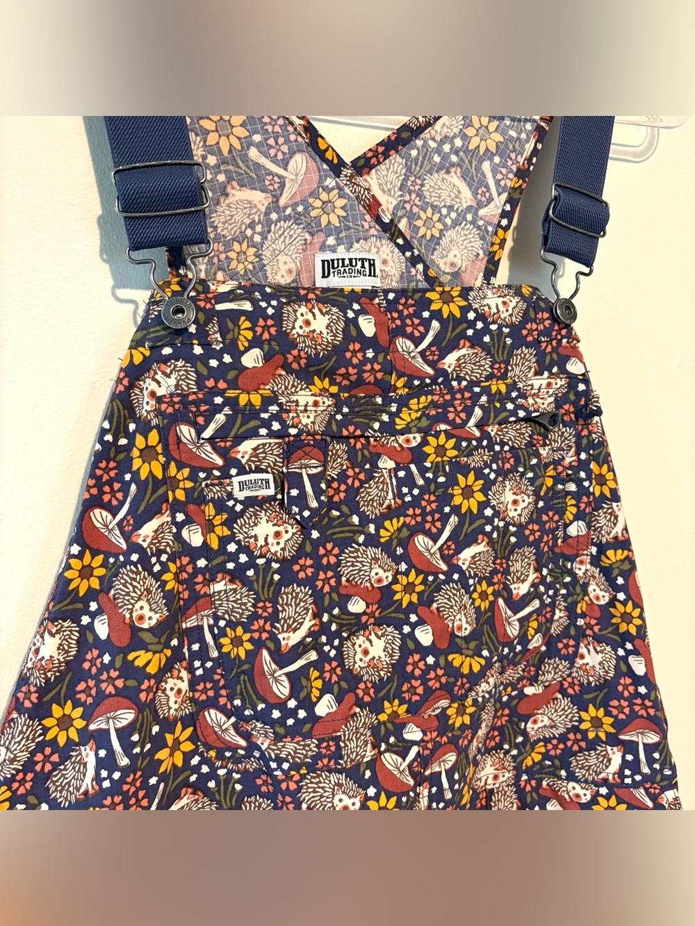 Duluth Heirloom gardening bib overalls in dusk blue with hedgehogs and mushrooms - Picture 3 of 7